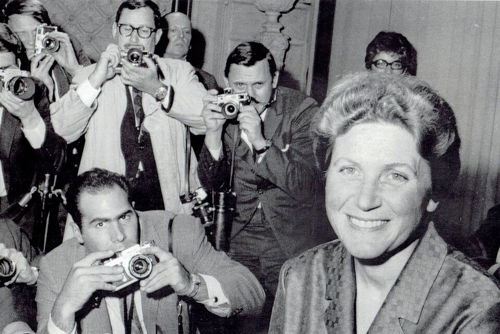 Svetlana Alliluyeva smiles at a New York press conference while photographers crowd behind her, April 26, 1967.