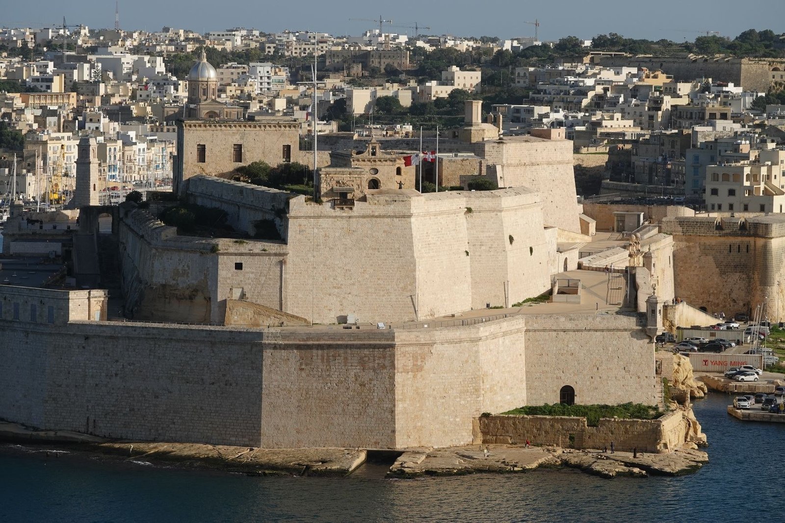 Fort St Angelo's pale stone fortifications at Birgu rising from the edge of Malta's Grand Harbour.