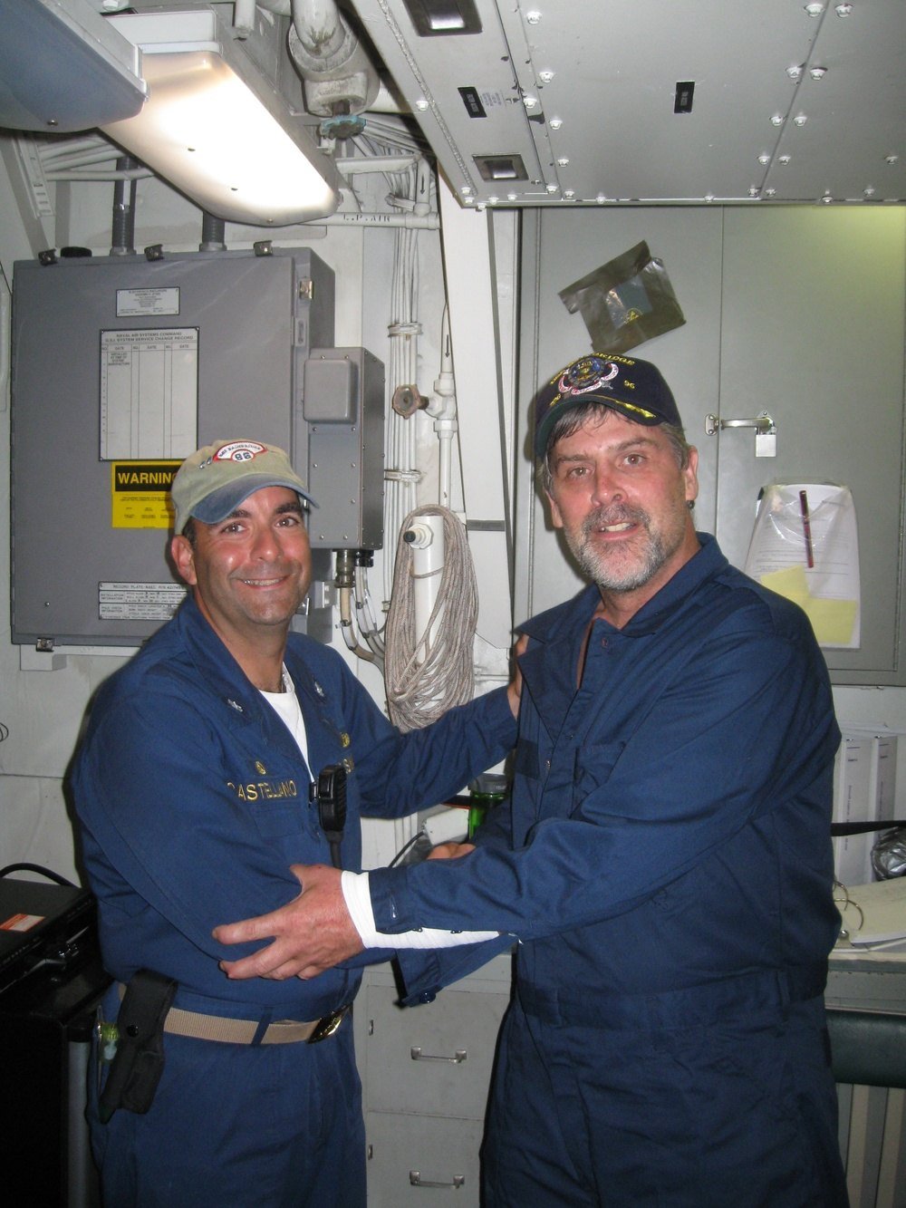 Richard Phillips stands beside USS Bainbridge commanding officer Frank Castellano after Phillips's rescue on 12 April 2009.