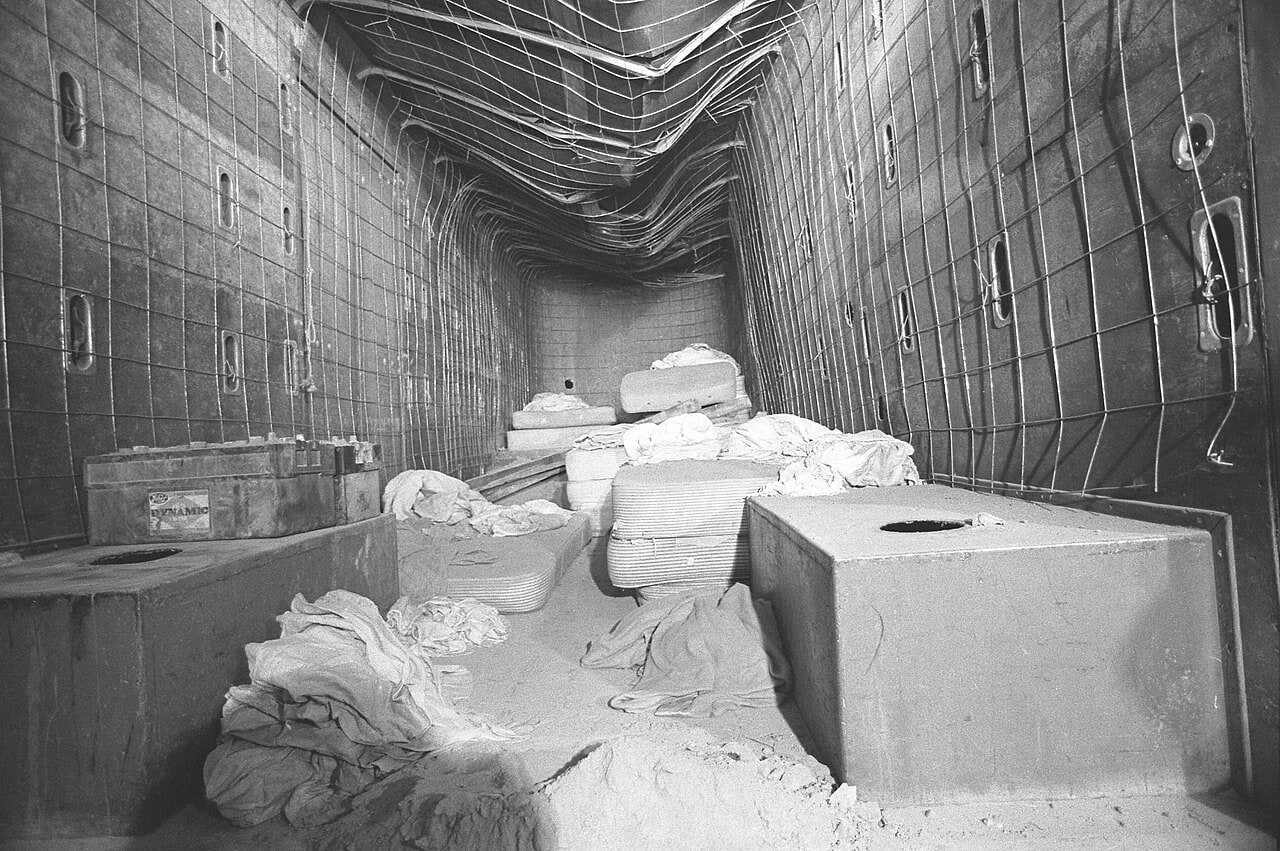 Black-and-white 1976 photograph showing the interior of the furniture van in which the Chowchilla kidnapping victims were confined underground.