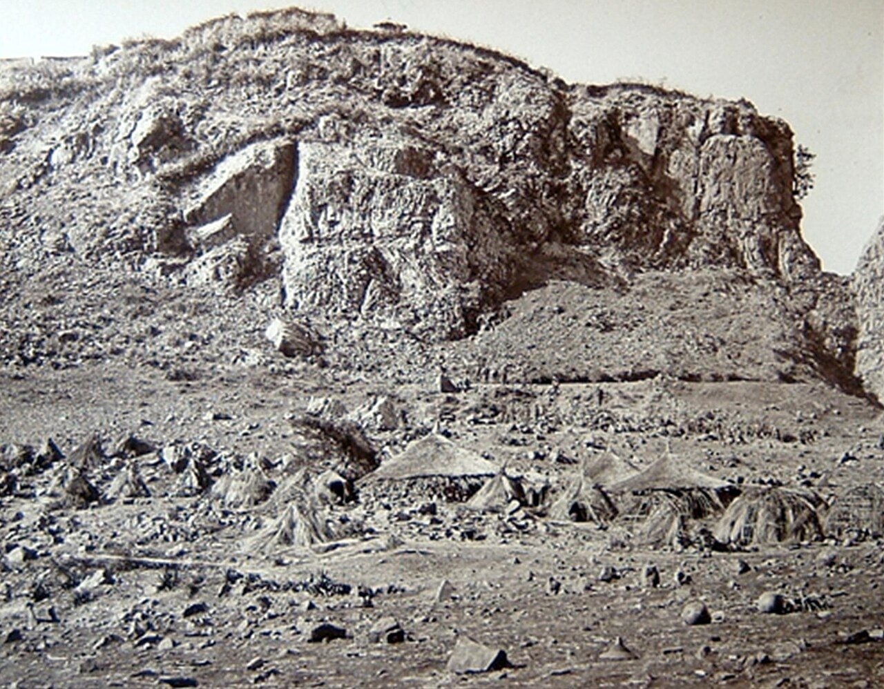 A rocky route rises toward the fortress of Magdala beneath steep cliffs in an 1868 photograph.