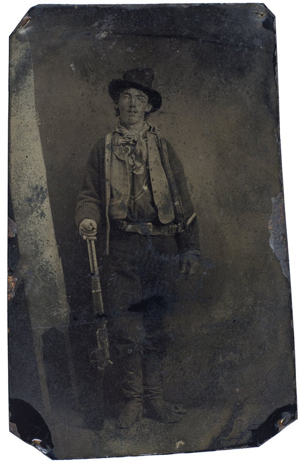Tintype portrait of Billy the Kid standing with a rifle, circa 1879 or 1880.