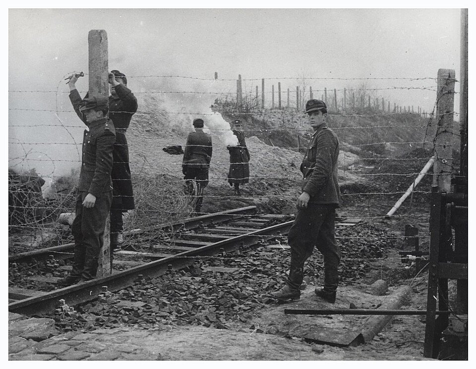 East German police removing rail tracks leading toward West Berlin in December 1961.