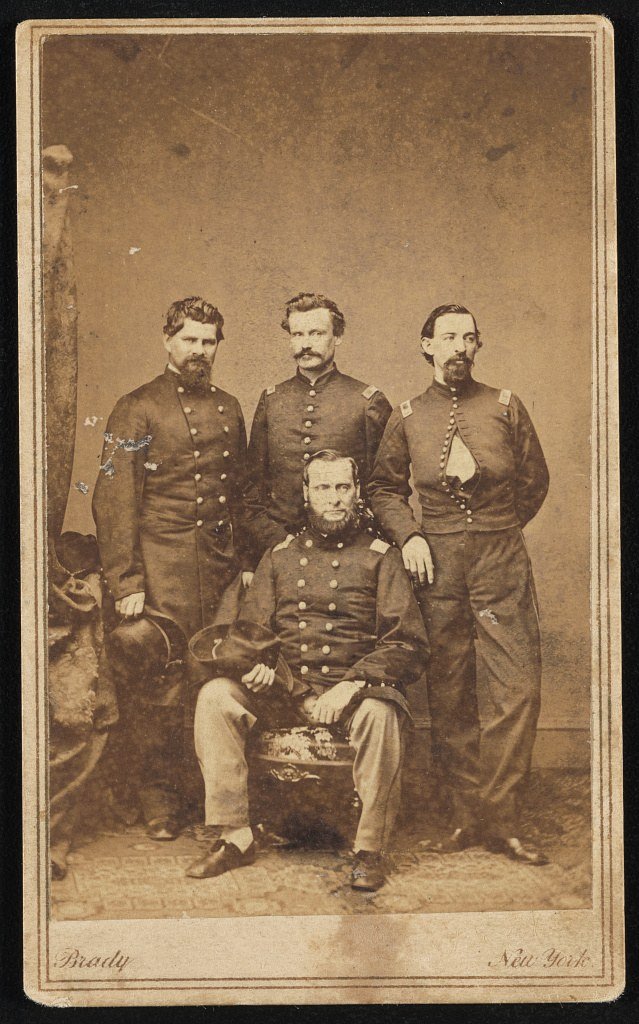 Civil War portrait of Abel Streight seated with Bedan McDonald, Henry Chamberlain and William Scearce standing behind him.