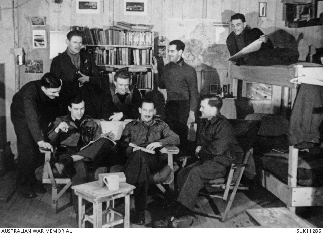Allied prisoners of war inside a furnished barrack room at Stalag Luft III around 1943.